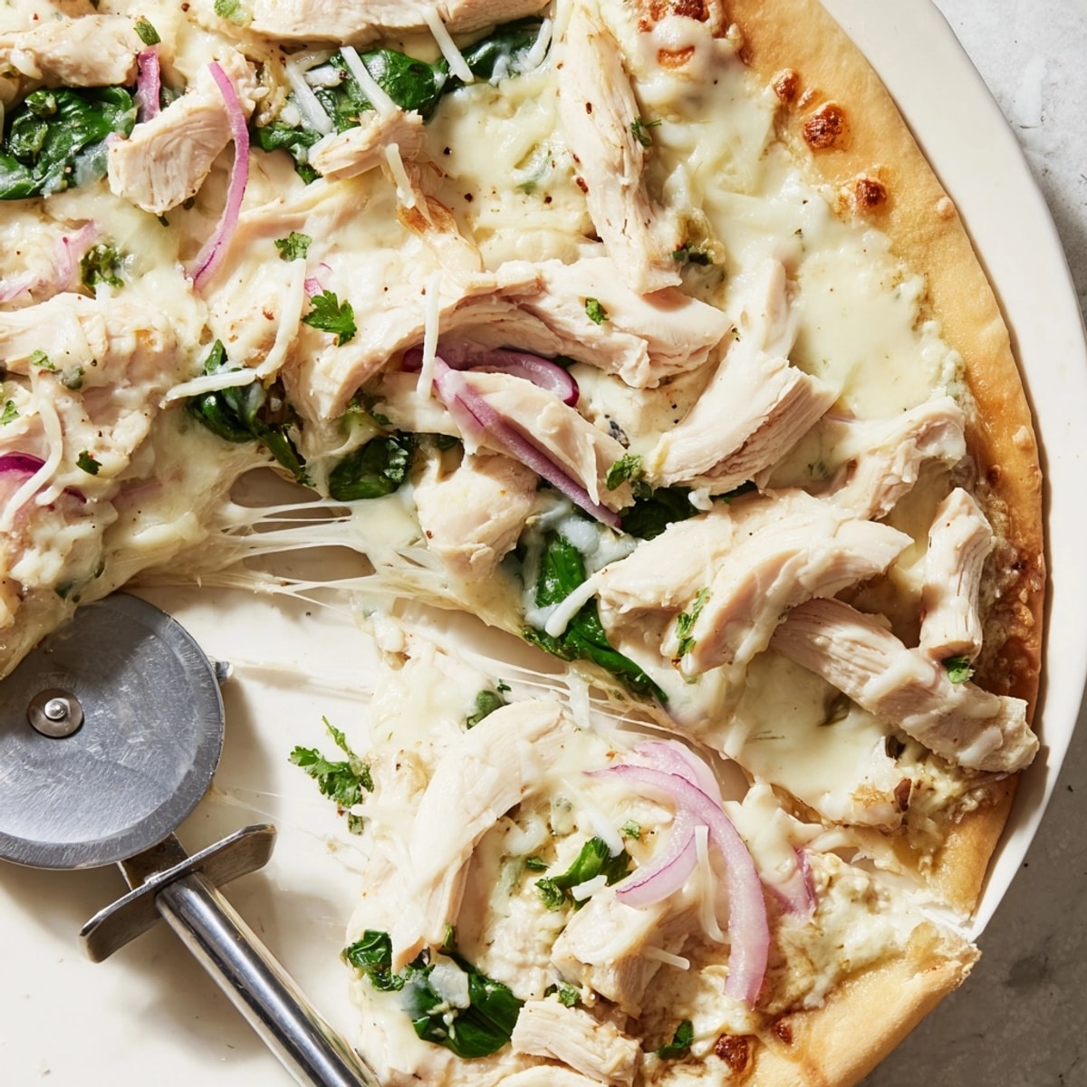 Homemade Chicken Alfredo Pizza, baking sheet presentation, inviting aroma promises a delightful meal.