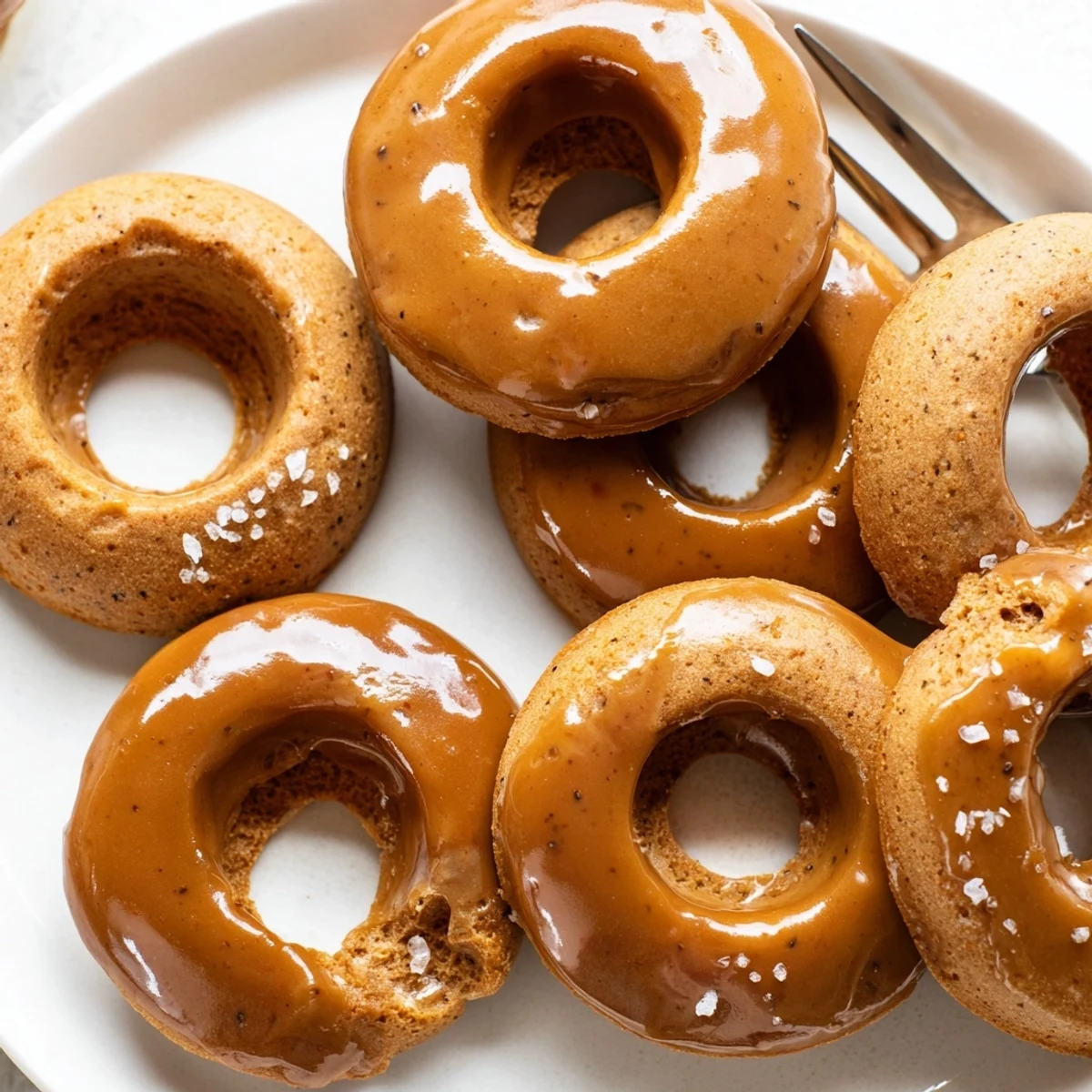 Fluffy Chai Caramel Coffee Pancake Donuts drizzled with warm, rich caramel glaze.