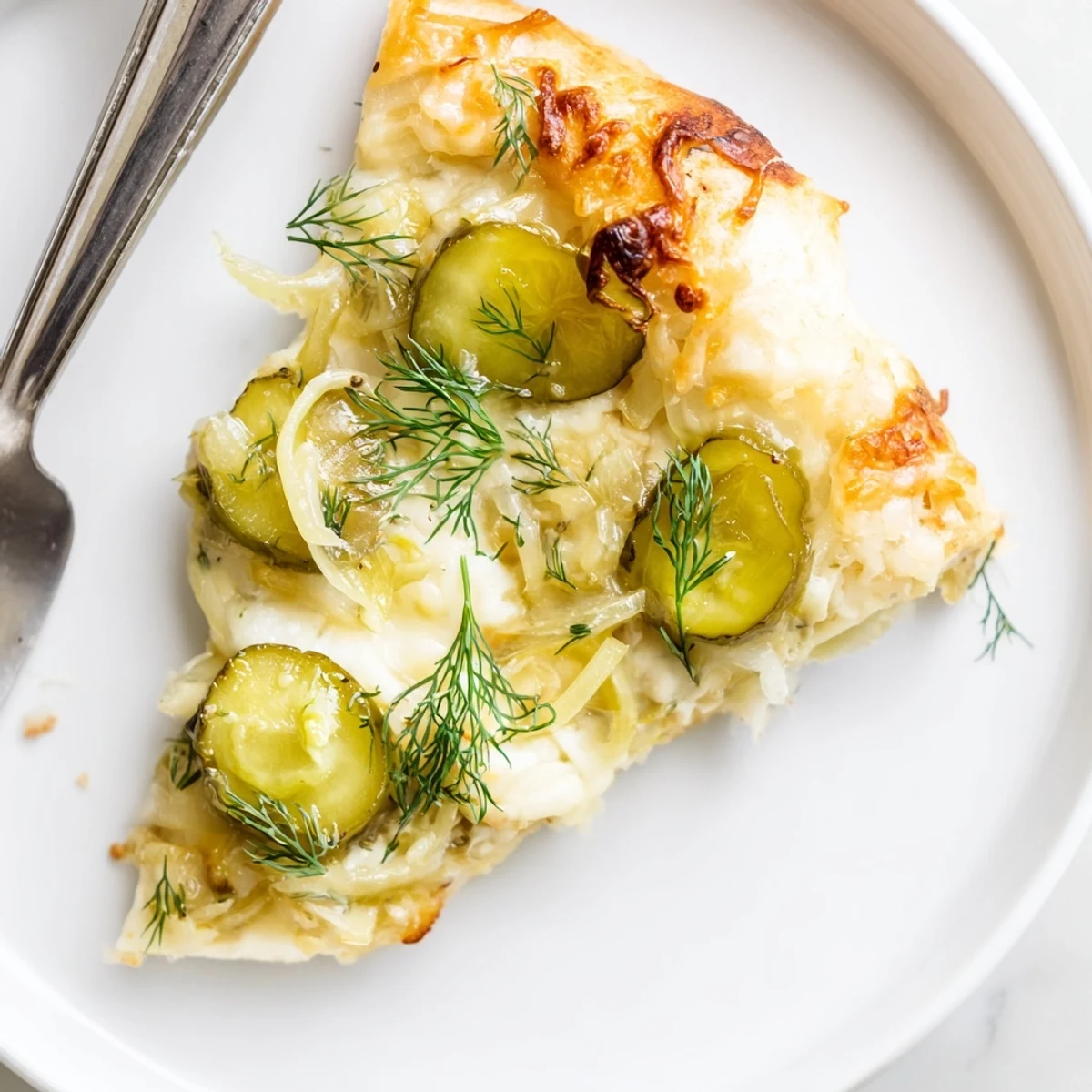 Creamy Pickle Pizza with tangy dill and crispy crust ready for slicing.  