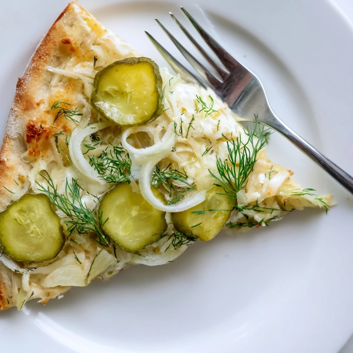 Vibrant Pickle Pizza showcasing creamy sauce, dill, and golden crust just baked.