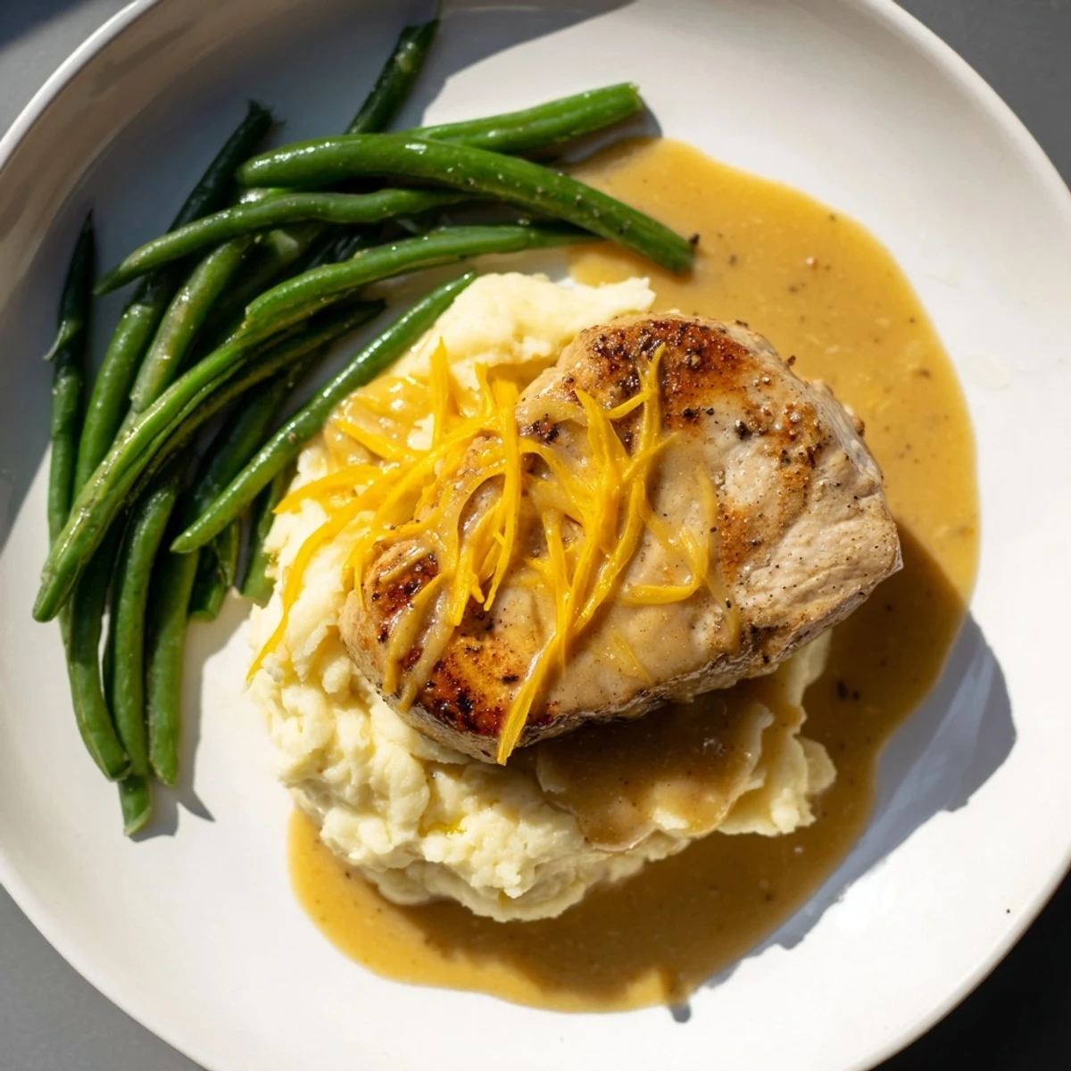 Tender pork chops and rich cheddar mashed potatoes star in this comforting Pork Chops & Cheddar Mash Bowl.