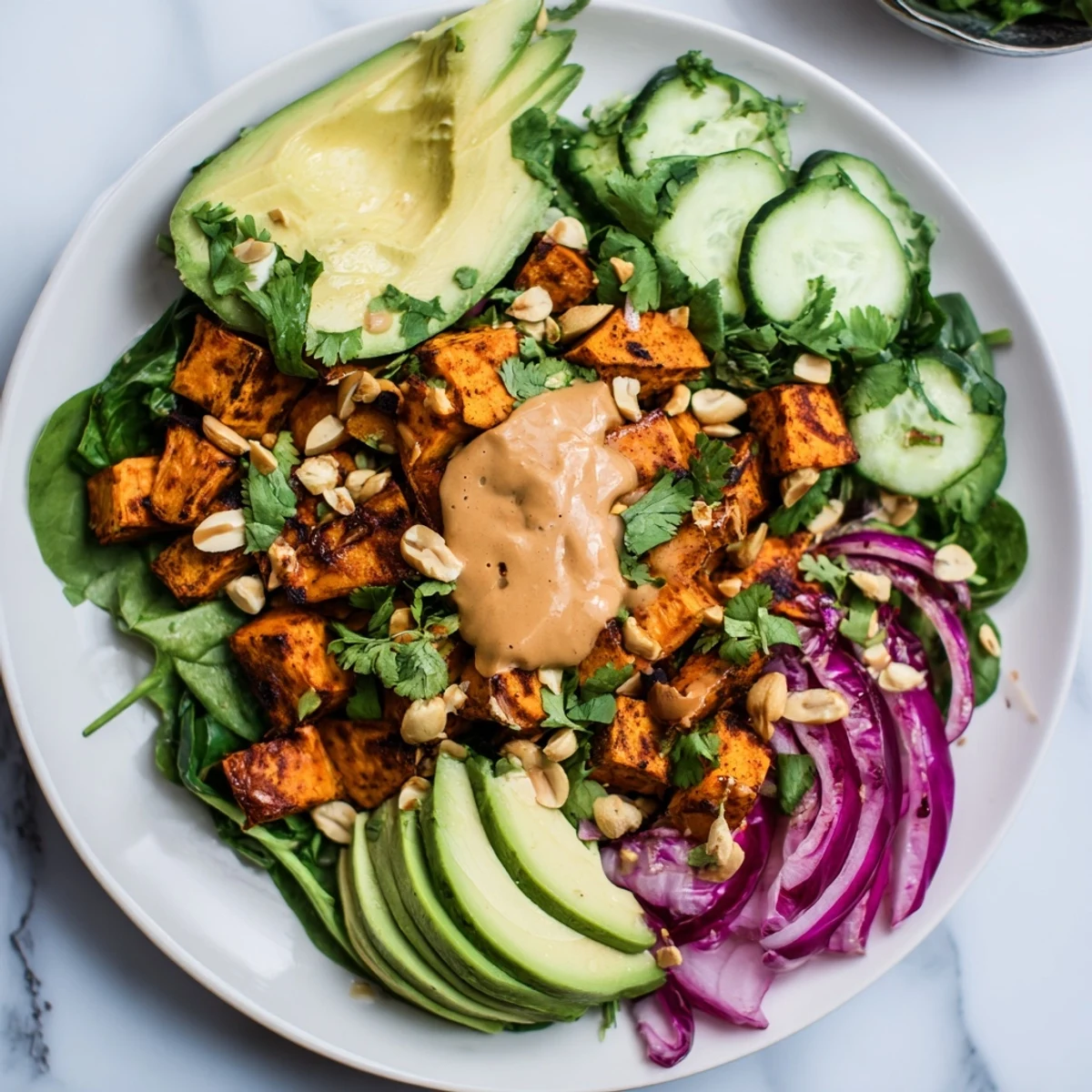 A healthy Spiced Peanut Sweet Potato & Radicchio Salad Bowl: a vegetarian delight with sweet potatoes and crunchy toppings.