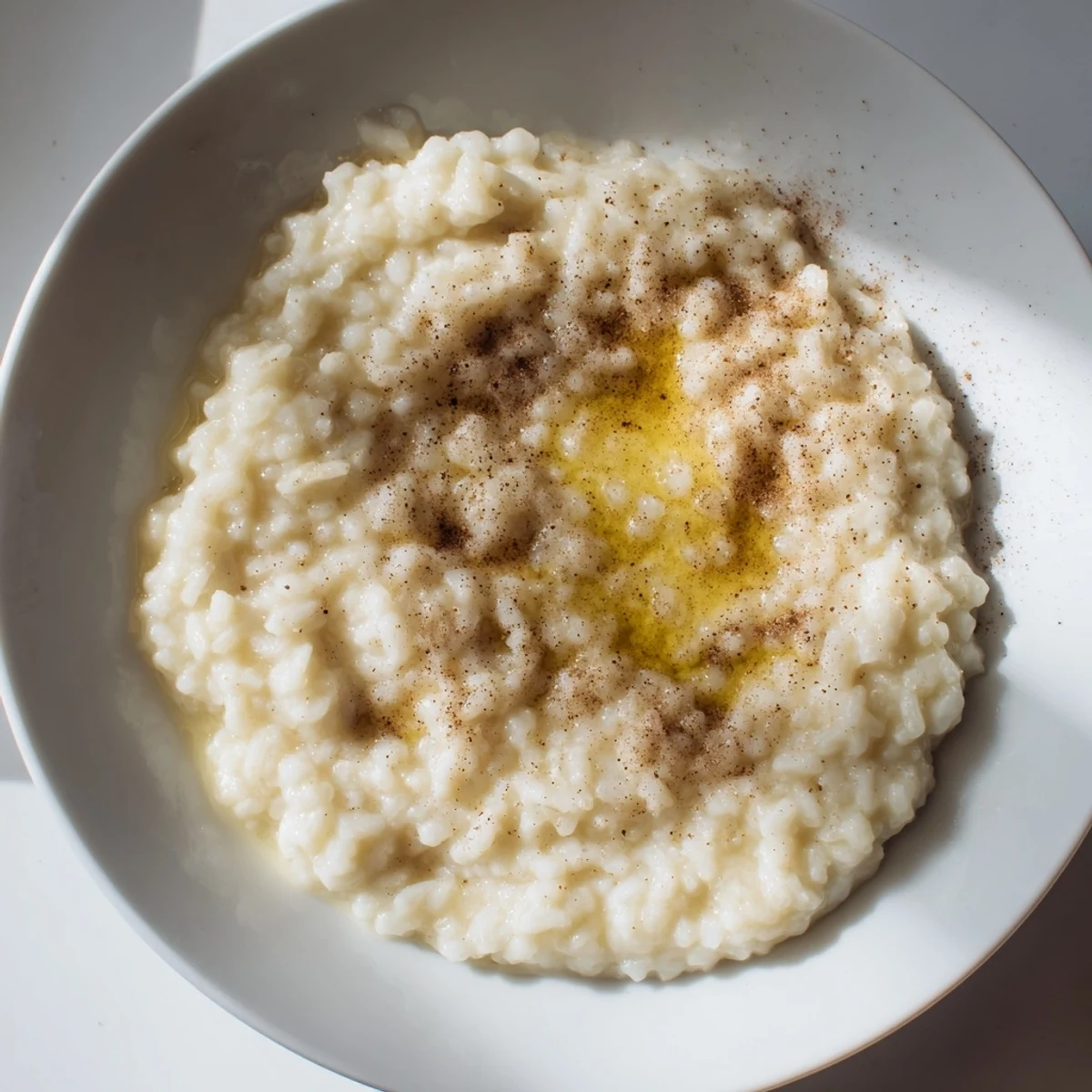 Creamy rice pudding with leftover rice, garnished with cinnamon, ready to serve warm or chilled.