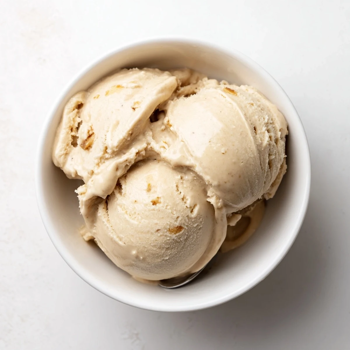 Creamy Peanut Butter Banana Ice Cream swirled in a bowl, ready to enjoy as a refreshing treat.