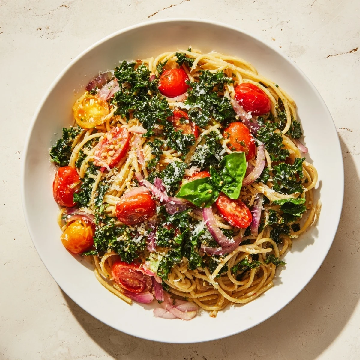 Steaming one-pot spaghetti with kale and tomatoes, ready with fresh basil for a flavorful dinner.