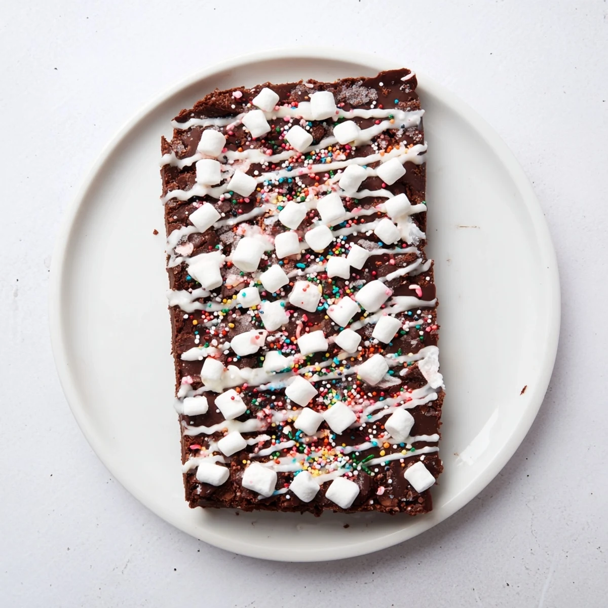 A beautifully decorated batch of vibrant hot chocolate bomb bark with peppermint and sprinkles, perfect for sharing.