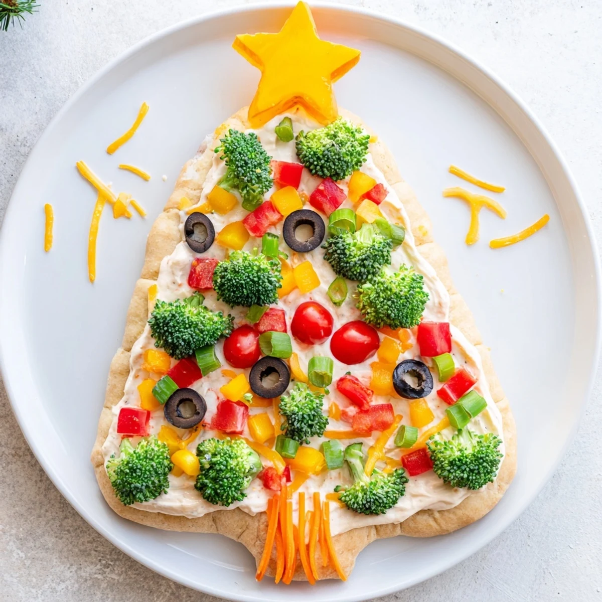 Creamy Easy Christmas Tree Veggie Pizza features a beautiful assortment of fresh, vibrant toppings.
