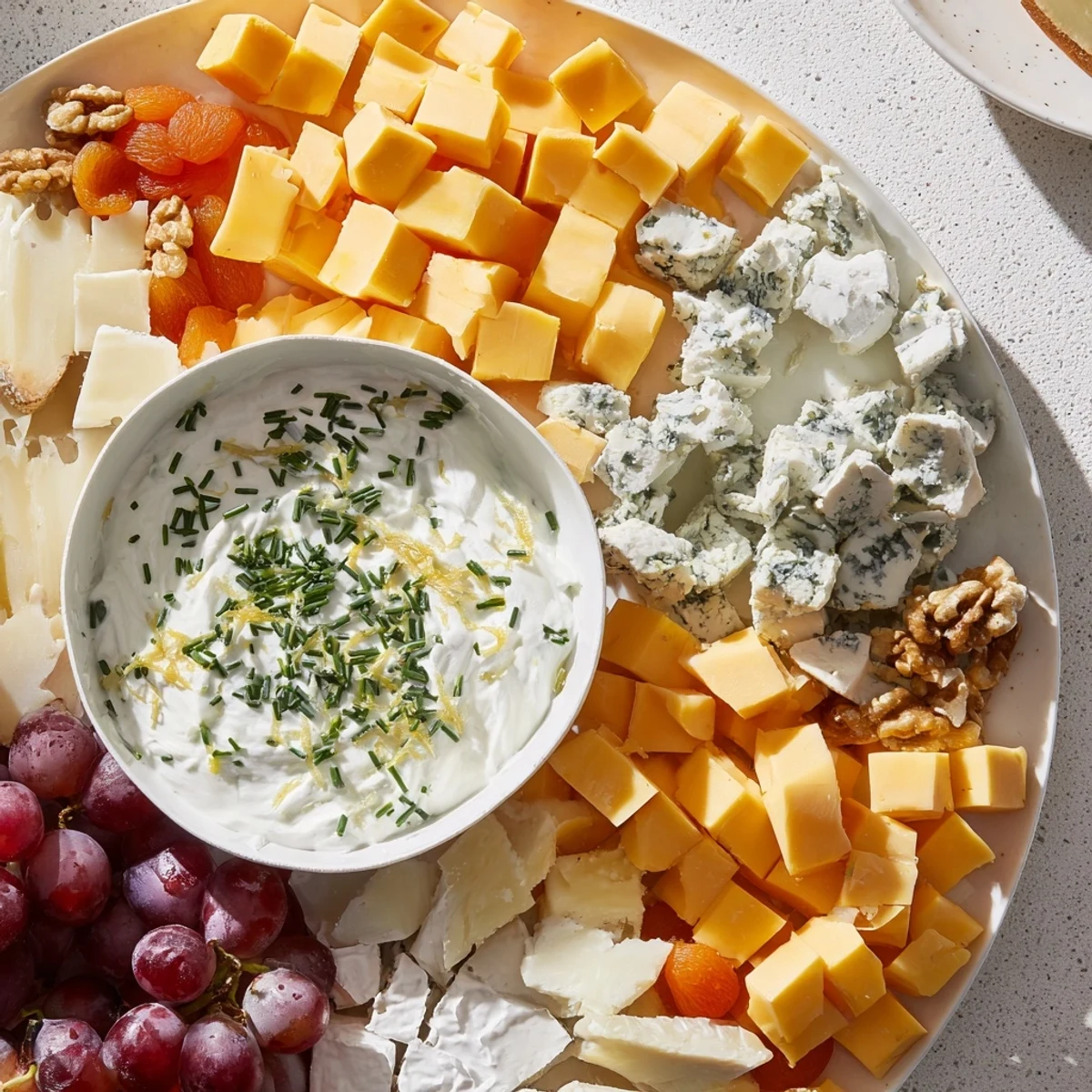 A beautifully arranged Celtic Cross Cheese Platter with assorted cheeses and vibrant accompaniments.