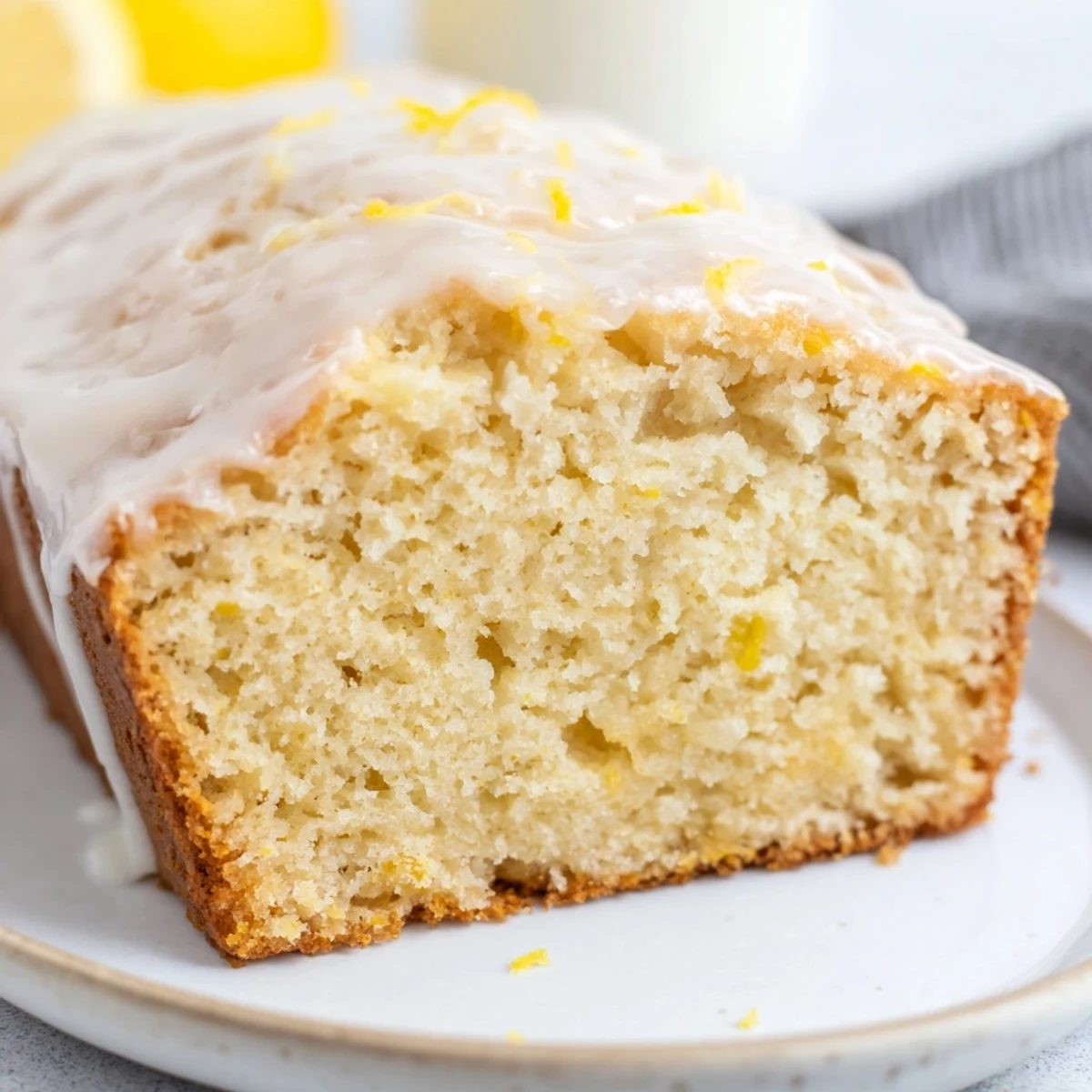 Freshly baked lemon yogurt cake, topped with a simple lemon glaze, ideal for sharing.