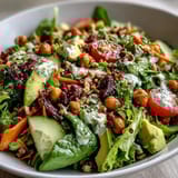 Fresh Mixed Greens Power Bowl topped with creamy avocado slices, crunchy walnuts, and vibrant veggies, perfect for a light and healthy meal.