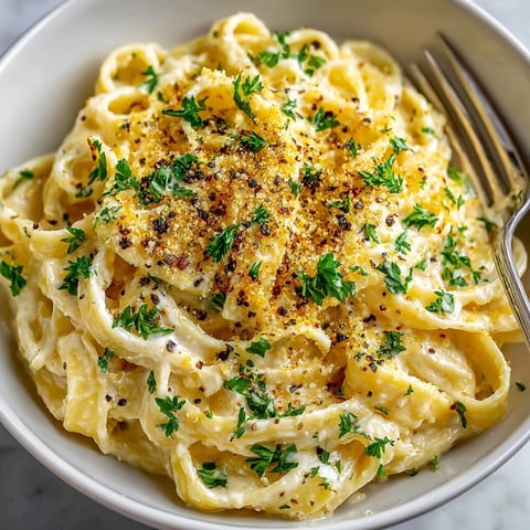 Creamy Cashew Alfredo Pasta, the vegan delight, topped with golden nutritional yeast Parmesan.