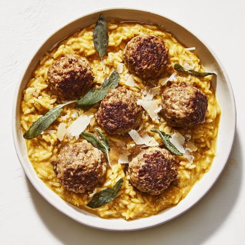 Flavorful sage turkey meatballs nestled with golden pumpkin orzo, a vibrant fall dinner.