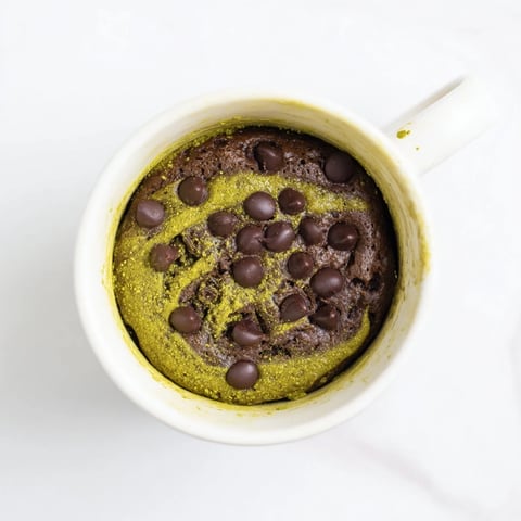 Steaming Matcha Peppermint Brownie Batter Mug Cake, a quick, single-serve dessert, rich and chocolatey.