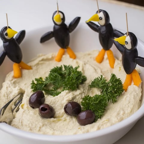 Delectable Winter Dip: creamy white bean dip topped with whimsical olive penguin garnishes.