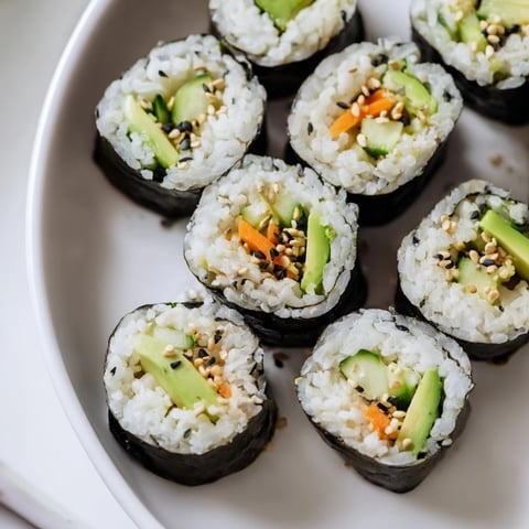 Beautifully arranged Avocado Cucumber Sushi rolls, showcasing fresh veggies and perfect rice for a healthy meal.