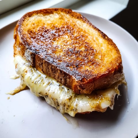 Golden, melty Truffle Oil Grilled Cheese oozing with cheddar, drizzled with fragrant truffle oil.