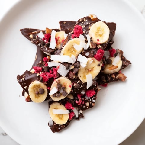 Frozen Chocolate Banana Bark with a delicious array of crunchy toppings ready to be enjoyed.