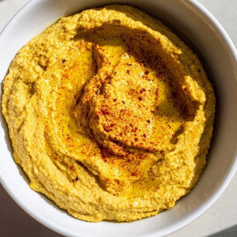 Rich, vibrant photo of the creamy Chickpea Curry Paste ready to be scooped up with pita bread.