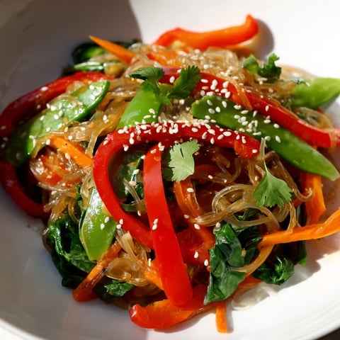 Bright, colorful Kelp Noodle Stir-Fry with crisp vegetables and sesame seeds, served on a plate ready to eat.