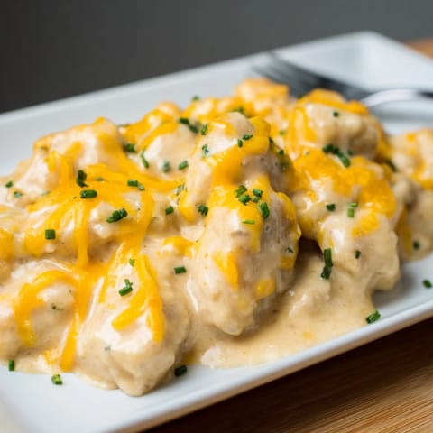 Juicy Cheddar Ranch Chicken Bake topped with bubbling cheese and vibrant herbs.  