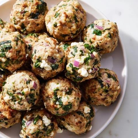 A close-up of baked Spinach Feta Turkey Meatballs showcasing the savory flavors and delightful texture.