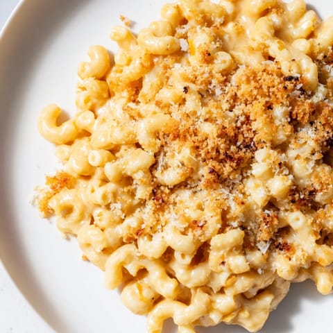 A steaming bowl of Butternut Squash Mac with melted cheese and tender, roasted squash visible.