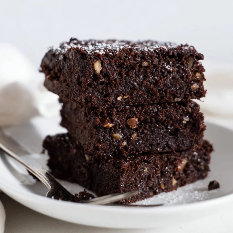 Irresistibly rich zero-waste brownies using nut-milk pulp, topped with chopped nuts and chocolate.