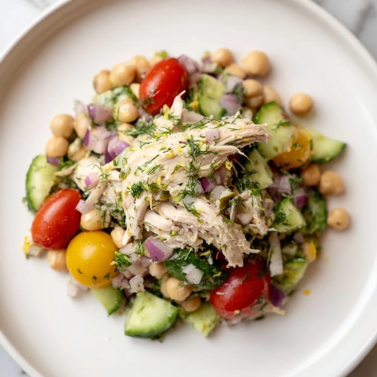 Enjoy this refreshing Dense Bean Salad with Lemon-Dill Chicken, featuring a bright, zesty dressing.