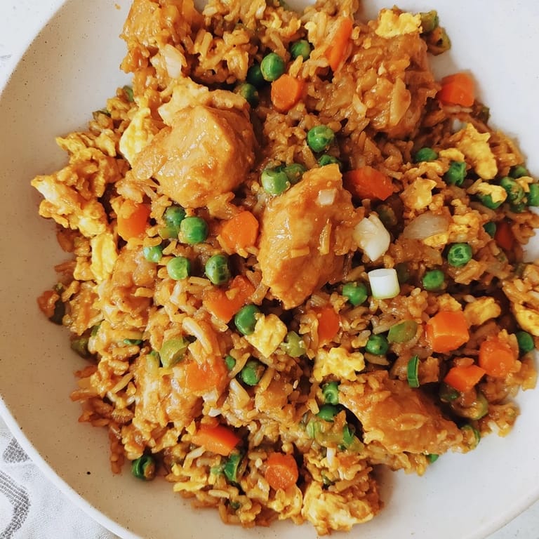 Savory Butter Chicken Fried Rice ready to eat, featuring fluffy rice mixed with chicken.
