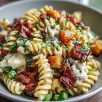 Vibrant Hawaiian pasta salad with ham, pineapple, and ranch dressing, perfect for summer gatherings.  